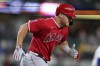 Los Angeles Angels' Mike Trout runs to first after hitting into a double play during the first inning of the team's baseball game against the Texas Rangers in Arlington, Texas, Tuesday, Sept. 20, 2022. Luis Rengifo was out at second. (AP Photo/Tony Gutierrez)