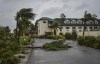 Fallen palm trees lay over the Ports of Call Resort entrance after the passage of Hurricane Fiona in Providenciales, Turks and Caicos Islands, Tuesday, Sept. 20, 2022. Residents of Atlantic Canada and the eastern edge of Quebec are being warned to brace for hurricane-force winds and intense rainfall as hurricane Fiona remains on track to slam into the East Coast late Friday. THE CANADIAN PRESS/AP/Vivian Tyson