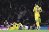 Ukrainian Valeriy Bondar, left, and Scotland's Che Adams lie injured after a challenge during the UEFA Nations League soccer match between Scotland and Ukraine, at Hampden Park, in Glasgow, Scotland, Wednesday, Sept. 21, 2022. (AP Photo/Scott Heppell)
