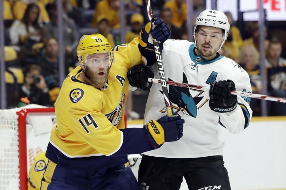FILE - Nashville Predators defenseman Mattias Ekholm (14), of Sweden, and San Jose Sharks center Tomas Hertl (48), of the Czech Republic, battle in the first period of an NHL hockey game Tuesday, Oct. 8, 2019, in Nashville, Tenn. The forthcoming NHL regular season’s games between the Nashville Predators and San Jose Sharks in Prague face an obstacle. The Czech Foreign Ministry has been opposing the participation of the Russian players from those teams in the Oct. 7 and 8 games at Prague’s O2 Arena due to Russia’s war against Ukraine. (AP Photo/Mark Humphrey, File)