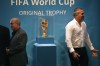 FILE - Iran's Football Federation President Mehdi Taj, left, and former Iran's national soccer team captain Ahmad Reza Abedzadeh stand next to the FIFA World Cup trophy after being revealed during the Trophy Tour, at Milad Tower hall in Tehran, Iran, Thursday, Sept. 1, 2022. German top division soccer club Hoffenheim is skipping this year's World Cup in Qatar. The club says on Thursday, Sept. 22, 2022, that it will not give any coverage to this year’s World Cup. (AP Photo/Vahid Salemi, File)