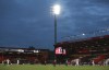 FILE - Players under the floodlights during the English Premier League soccer match between Bournemouth and Crystal Palace at Vitality Stadium in Bournemouth, England, Saturday, June 20, 2020. An English soccer club has brought forward the kickoff time of one of its league games as a trial run amid efforts to save money as energy costs escalate. Mansfield's fourth-tier League Two game against Walsall on Oct. 15, 2022 had a scheduled kickoff at 3 p.m. local time but it will now start at 1 p.m. (AP Photo/Ian Walton, Pool, File)