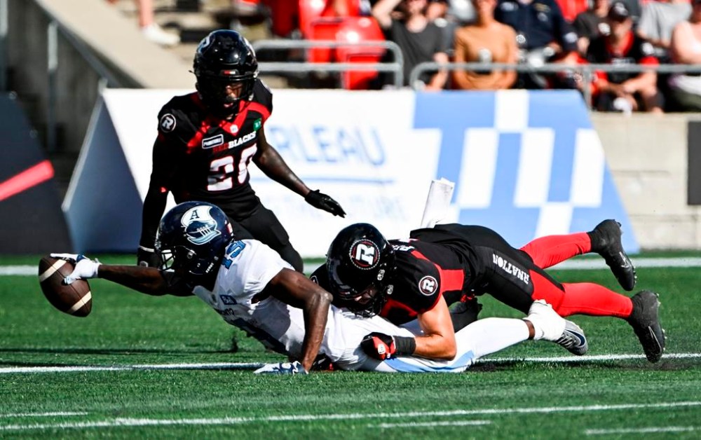 Toronto Argonauts wide receiver Kurleigh Gittens Jr. (19) reaches out to make a touchdown as Ottawa Redblacks defensive back Antoine Pruneau (6) is unable to stop him, during second half CFL football action in Ottawa on Saturday, Sept. 10, 2022. Ottawa (3-9-0) hosts the Toronto Argonauts (7-5-0) Saturday night and will need to be much better than they were two weeks ago when they lost 24-19 to the Argos. THE CANADIAN PRESS/Justin Tang