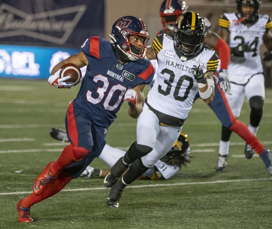 Montreal Alouettes' Chandler Worthy outruns Hamilton Tiger-Cats' Stavros Katsantonis during second half CFL football action in Montreal on Friday, Sept. 23, 2022. THE CANADIAN PRESS/Peter McCabe