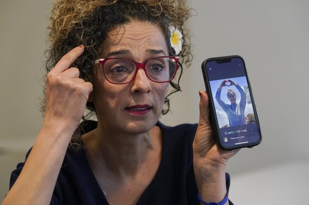 Iranian dissident Masih Alinejad hold up a photo of an Iranian woman who was killed during the current protest in Iran as speaks during an interview with The Associated Press, Friday, Sept. 23, 2022, in New York. (AP Photo/Mary Altaffer)
