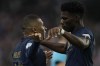 France's Kylian Mbappe, left, celebrates with France's Aurelien Tchouameni after Mbappe scored his side's first goal during the UEFA Nations League soccer match between France and Austria at the Stade de France stadium in Saint Denis, outside Paris, France,Thursday, Sept. 22, 2022. (AP Photo/Christophe Ena)