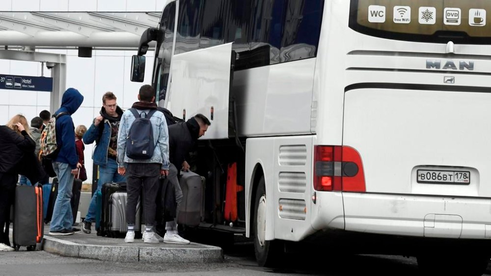 Passengers get off a coach from St. Petersburg, Russia, at the Helsinki Airport in Vantaa, Finland, Saturday Sept. 24, 2022. Finland border guards said Friday that the number of people entering from Russia has climbed sharply, with media reporting a 107% increase compared with last week. (Jussi Nukari/Lehtikuva via AP)