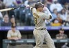 San Diego Padres' Manny Machado singles off Colorado Rockies starting pitcher Chad Kuhl in the first inning of a baseball game Saturday, Sept. 24, 2022, in Denver. (AP Photo/David Zalubowski)