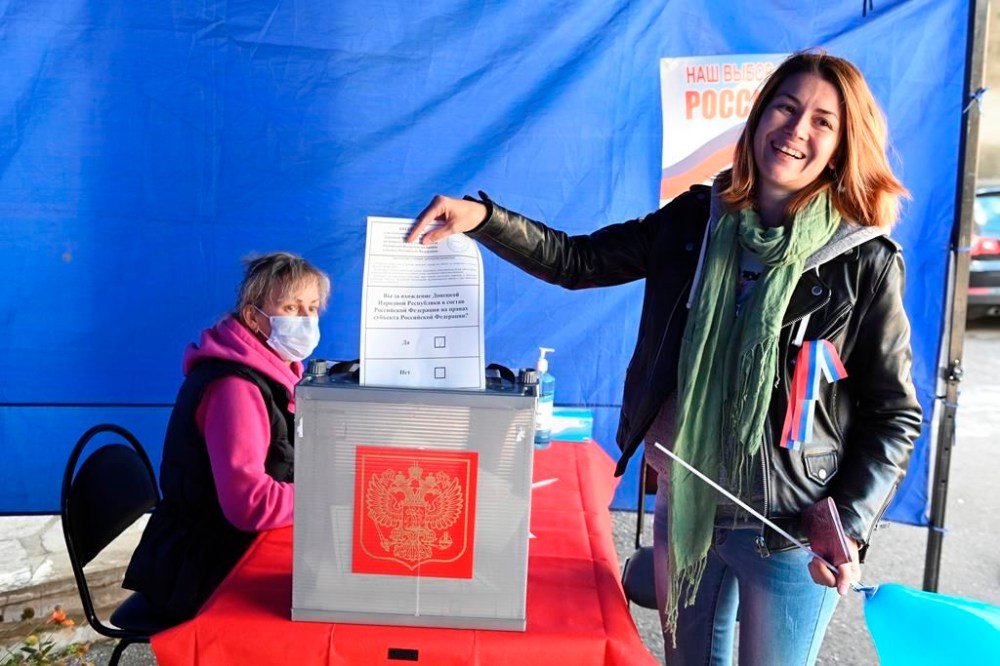 A woman who lives in Russia, from the Donetsk region, the territory controlled by a pro-Russia separatist government, holds her ballot during a referendum at a temporary accommodation facility in the Novocherkassk, Rostov-on-Don region of Russia, Saturday, Sept. 24, 2022. Voting began Friday in four Moscow-held regions of Ukraine on referendums to become part of Russia. Polls also opened in Russia, where refugees from regions under Russian control can cast their votes. (AP Photo)