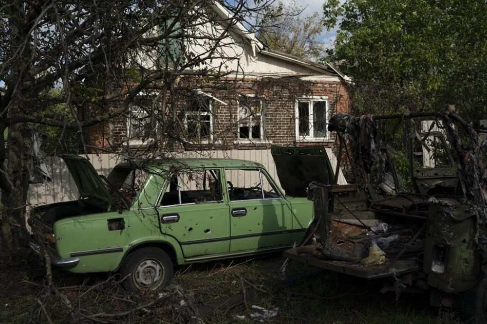 Damaged cars in the retaken village of Shchurove, Ukraine, Sunday, Sept. 25, 2022. (AP Photo/Leo Correa)