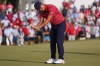 Collin Morikawa misses his putt on the 15th green during their singles match at the Presidents Cup golf tournament at the Quail Hollow Club, Sunday, Sept. 25, 2022, in Charlotte, N.C. (AP Photo/Julio Cortez)