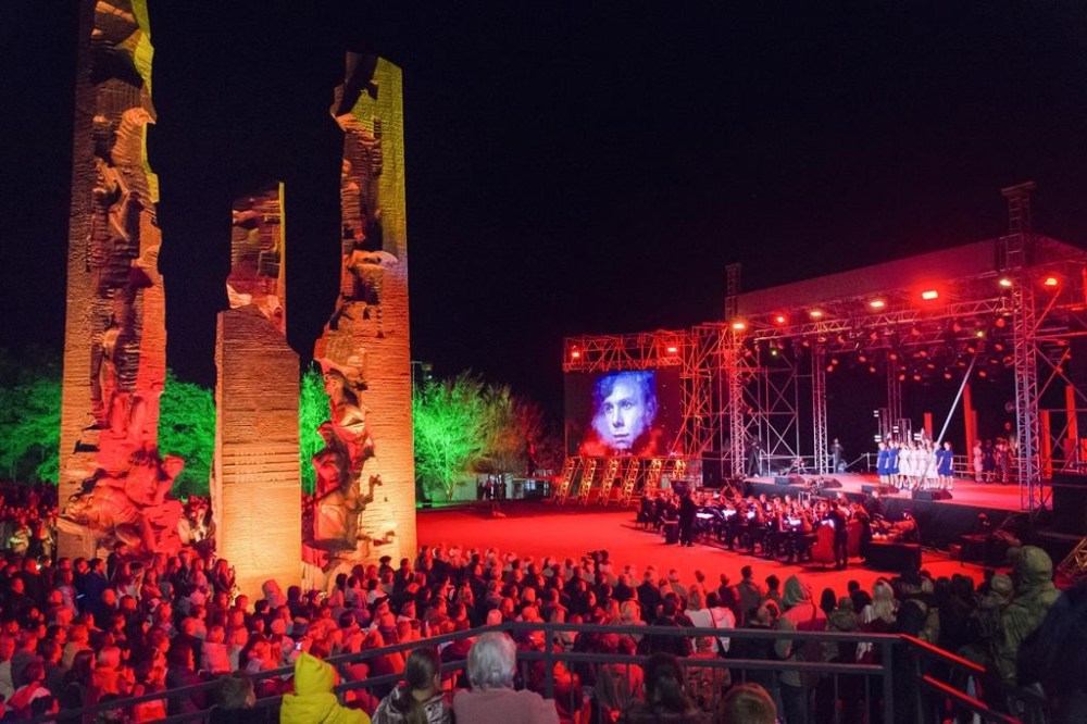 Actors perform during a concert at a monument to the Young Guards
