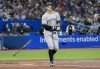 New York Yankees right fielder Aaron Judge (99) tosses his bat as he gets walked by Toronto Blue Jays starting pitcher Kevin Gausman (34) during third inning American League MLB baseball action in Toronto on Monday, September 26, 2022. THE CANADIAN PRESS/Nathan Denette