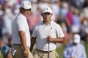Tom Kim, of South Korea, left, and Si Woo Kim, of South Korea, look at the 15th green during their fourball match at the Presidents Cup golf tournament at the Quail Hollow Club, Saturday, Sept. 24, 2022, in Charlotte, N.C. (AP Photo/Julio Cortez)