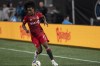 Toronto FC forward Jayden Nelson brings the ball upfield during the first half of an MLS soccer match against Charlotte FC, Saturday, Aug. 27, 2022, in Charlotte, N.C. (AP Photo/Matt Kelley)