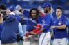 Toronto Blue Jays first baseman Vladimir Guerrero Jr. (27) celebrates with teammates after hitting the game winning RBI single against the New York Yankees during tenth inning American League MLB baseball action in Toronto on Monday, September 26, 2022. THE CANADIAN PRESS/Cole Burston