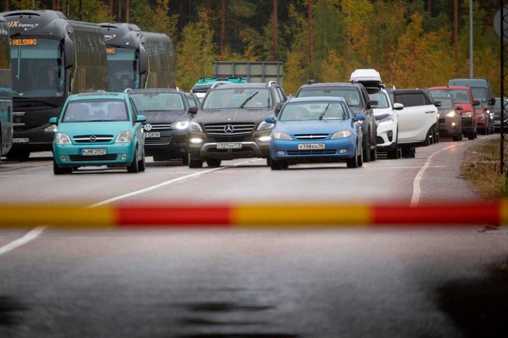 Russian cars and buses line up at the Vaalimaa border check point between Finland and Russia in Virolahti, Finland, Friday, Sept. 30, 2022. The Finnish-Russia border was closed Friday after the Nordic country announced it would ban Russians with tourist visas from entering, curtailing one of the last easily accessible routes to Europe for Russians trying to flee a military mobilization. Long queues were reported until midnight and among the last to enter Finland were two cyclists who arrived a little before 11 p.m., Finnish broadcaster YLE reported. (Sasu Makinen./Lehtikuva via AP)