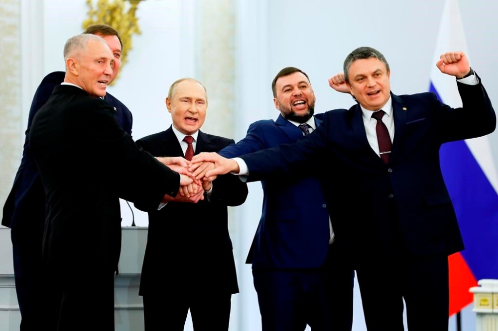 From left, Moscow-appointed head of Kherson Region Vladimir Saldo, Moscow-appointed head of Zaporizhzhia region Yevgeny Balitsky, Russian President Vladimir Putin, Denis Pushilin, leader of self-proclaimed of the Donetsk People's Republic and Leonid Pasechnik, leader of self-proclaimed Luhansk People's Republic pose for a photo during a ceremony to sign the treaties for four regions of Ukraine to join Russia, at the Kremlin in Moscow, Friday, Sept. 30, 2022. The signing of the treaties making the four regions part of Russia follows the completion of the Kremlin-orchestrated
