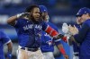 Toronto Blue Jays first baseman Vladimir Guerrero Jr. (27) celebrates with teammates after hitting the game winning RBI single against the New York Yankees during tenth inning American League MLB baseball action in Toronto on Monday, September 26, 2022. THE CANADIAN PRESS/Cole Burston