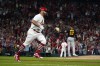 St. Louis Cardinals' Albert Pujols, left, rounds the bases after hitting a solo home run off Pittsburgh Pirates starting pitcher Johan Oviedo (62) during the fourth inning of a baseball game Friday, Sept. 30, 2022, in St. Louis. (AP Photo/Jeff Roberson)