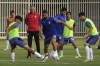 Iran's national soccer team head coach Carlos Queiroz, in red, watches a training session in Tehran, Iran, Wednesday, Sept. 14, 2022. Queiroz was rehired as Iran's coach on Wednesday, Sept. 7, to take the national soccer team to its third straight World Cup. (AP Photo/Vahid Salemi)