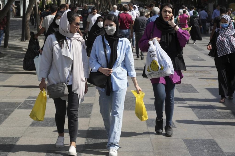 Women shop in the old main bazaar of Tehran, Iran, Saturday, Oct. 1, 2022. Thousands of Iranians have taken to the streets over the last two weeks to protest the death of Mahsa Amini, a 22-year-old woman who had been detained by the morality police in the capital of Tehran for allegedly wearing her mandatory Islamic veil too loosely. (AP Photo/Vahid Salemi)