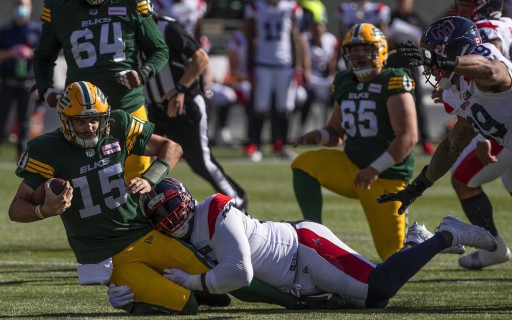 Montreal Alouettes Almondo Sewell (90) sacks Edmonton Elks quarterback Taylor Cornelius (15) during first half CFL action in Edmonton, Alta., on Saturday October 1, 2022. THE CANADIAN PRESS/Jason Franson.