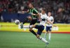 Austin FC's Maxi Urruti, left, and Vancouver Whitecaps' Ranko Veselinovic vie for the ball during the first half of an MLS soccer game in Vancouver, on Saturday, October 1, 2022. THE CANADIAN PRESS/Darryl Dyck