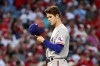 Texas Rangers starting pitcher Cole Ragans looks at his cap after throwing to a Los Angeles Angels batter during the first inning of a baseball game in Anaheim, Calif., Saturday, Oct. 1, 2022. (AP Photo/Ringo H.W. Chiu)