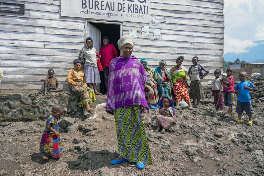 Pasika Bagerimana stands outside a temporary shelter she shares with others who fled fighting, in Nyiragongo, Democratic Republic of Congo, Aug. 31, 2022. Bagerimana, who lost two children to hunger, worries her remaining two children might be next.