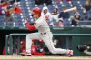 Philadelphia Phillies' Bryson Stott follows through on an RBI-fielder's choice to second base during the second inning of a baseball game against the Washington Nationals, Sunday, Oct. 2, 2022, in Washington. (AP Photo/Luis M. Alvarez)