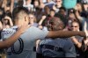 Sporting Kansas City midfielder William Agada, right, celebrates with forward Dániel Sallói (20) after scoring a goal during the first half of an MLS soccer match against the Seattle Sounders Sunday, Oct. 2, 2022, in Kansas City, Kan. (AP Photo/Charlie Riedel)