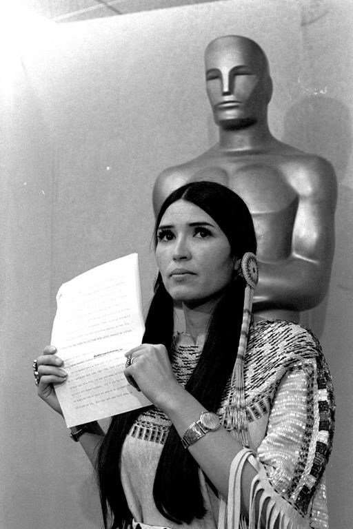 FILE - Sacheen Littlefeather, a Native American activist, tells the audience at the Academy Awards ceremony in Los Angeles, March 27, 1973, that Marlon Brando was declining to accept his Oscar as best actor for his role in