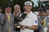 Mackenzie Hughes of Canada hoists the Sanderson Farms Championship golf tournament trophy in Jackson, Miss., Sunday, Oct. 2, 2022. Hughes won on the second hole of a sudden death playoff. THE CANADIAN PRESS/AP/Rogelio V. Solis