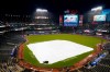 Security stands on the field as rain falls before a baseball game between the New York Yankees and the Baltimore Oriole, Monday, Oct. 3, 2022, in New York. (AP Photo/Frank Franklin II)