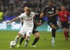 Tottenham's Harry Kane challenges for the ball with Frankfurt's Makoto Hasebe during the Champions League Group D soccer match between Eintracht Frankfurt and Tottenham Hotspurs in Frankfurt, Germany, Tuesday, Oct.4, 2022. (AP Photo/Michael Probst)
