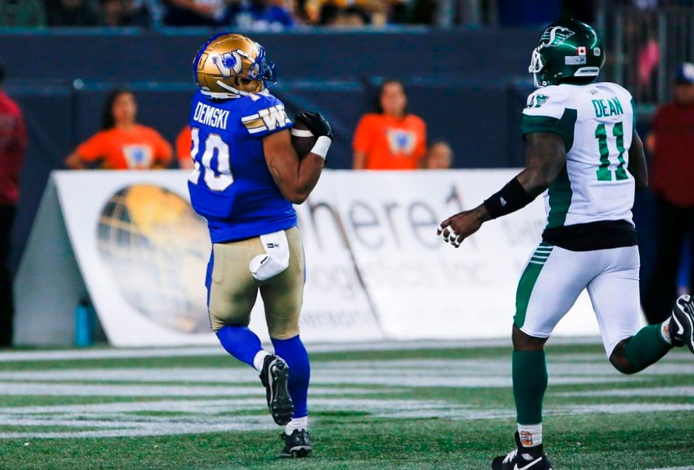 Winnipeg Blue Bombers' Nic Demski (10) catches a touchdown pass as Saskatchewan Roughriders' Larry Dean (11) looks on during second half CFL action in Winnipeg Friday, September 30, 2022. Quarterback Zach Collaros and receiver Demski of the Winnipeg Blue Bombers and Calgary Stampeders linebacker Jameer Thurman were named the CFL’s top performers for September on Wednesday.THE CANADIAN PRESS/John Woods
