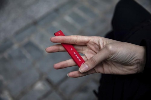 FILE - In this Jan. 31, 2020 photo a woman holds a flavored disposable vape device in New York. A government study on adolescent vaping, released on Thursday, Oct. 6, 2022, finds more than 2.5 million U.S. kids were using some form of e-cigarette in 2022, suggesting there’s been little progress in keeping vaping devices out of the hands of teenagers. (AP Photo/Marshall Ritzel, File)