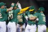 Oakland Athletics' Shea Langeliers (23) is mobbed by teammates after earning a walk with the bases loaded against the Los Angeles Angels during the 10th inning of a baseball game in Oakland, Calif., Tuesday, Oct. 4, 2022. The Athletics won 2-1 when Tony Kemp scored. (AP Photo/Godofredo A. Vásquez)