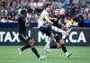 Vancouver Whitecaps' Brian White, centre, receives a pass between Minnesota United's Bakaye Dibassy, left, and Michael Boxall during the second half of an MLS soccer game in Vancouver, B.C., Friday, July 8, 2022. THE CANADIAN PRESS/Darryl Dyck