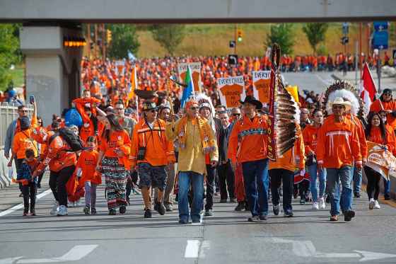 MIKE DEAL / WINNIPEG FREE PRESS Hundreds of people take part in the march towards the RBC Convention Centre from The Forks Friday morning.
