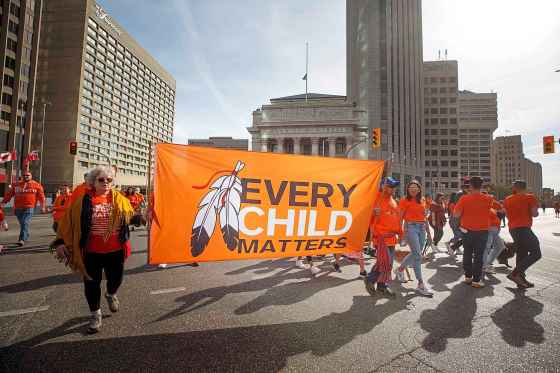 MIKE DEAL / WINNIPEG FREE PRESS Hundreds of people take part in the march towards the RBC Convention Centre from The Forks Friday morning.