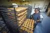 MIKE DEAL / WINNIPEG FREE PRESS
                                Meier waits with a batch of doughnuts that will be boxed and then shipped off to various grocery stores in the city.