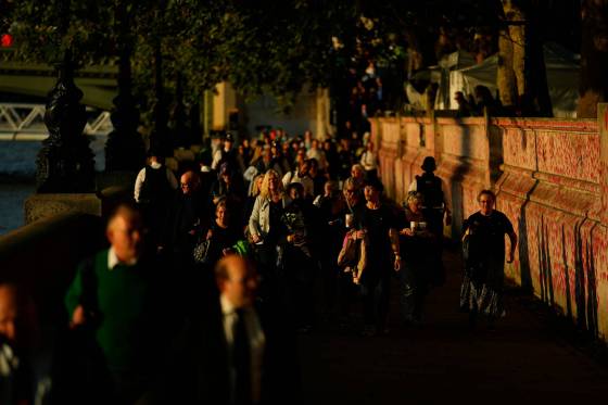 People queue to pay their respects to late Queen Elizabeth II, whose body is lying in state at Westminster Hall in London. (David Josek / The Associated Press)