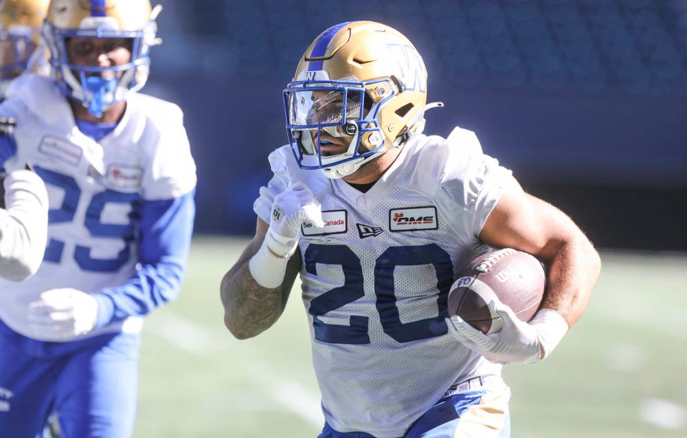 RUTH BONNEVILLE / WINNIPEG FREE PRESS
Bombers running back Brady Oliveira had a productive bye week, rescuing canines and teaming up with wide receiver Rasheed Bailey to speak to students in Grand Forks, N.D.
RUTH BONNEVILLE / WINNIPEG FREE PRESS Sports - Bomber practice BRADY OLIVEIRA #20 RUNNING BACK practices with team at IG Field Monday. Sept 26th, 2022