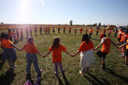 TIM SMITH / BRANDON SUN
                                Kids from all races are playing, arguing, and working together — united in orange.