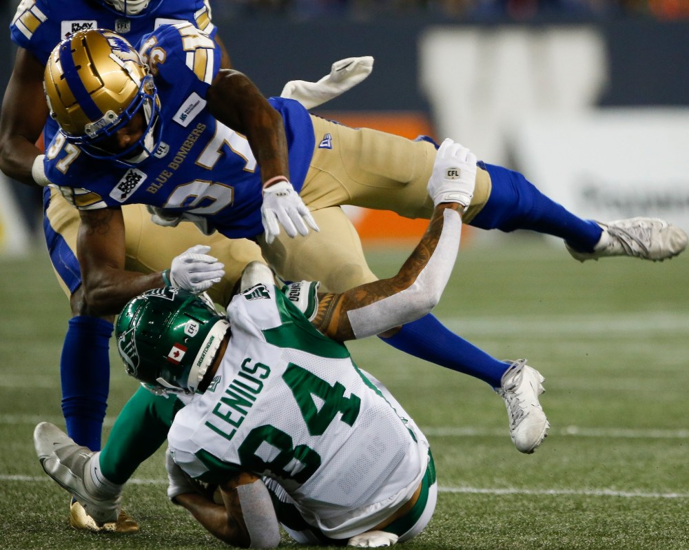 THE CANADIAN PRESS/John Woods
Winnipeg Blue Bombers' Brandon Alexander tackles Saskatchewan Roughriders' Brayden Lenius during the first half.
