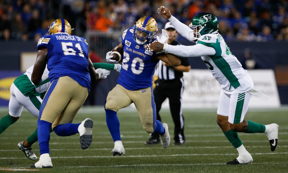 THE CANADIAN PRESS/John Woods
Winnipeg Blue Bombers' Brady Oliveira runs for a first down against the Saskatchewan Roughriders during the first half in Winnipeg, Friday.