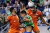 FC Cincinnati defender Nick Hagglund wins a header over Seattle Sounders FC defender Jackson Ragen as he is sandwiched by defender Geoff Cameron, left, on a corner kick during the first half of an MLS soccer game, Tuesday, Sept. 27, 2022 in Seattle. (Jennifer Buchanan/The Seattle Times via AP)