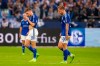 Schalke's Marius Bülter, left, and Schalke's Sebastian Polter go into the dressing room with their heads down after losing the German Bundesliga soccer match between FC Augsburg and Schalke 04 at the Veltins Arena in Gelsenkirchen, Germany, Sunday Oct. 2, 2022. (David Inderlied/dpa via AP)